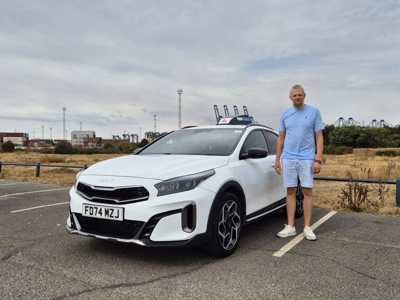 Gvidas Bytautas standing beside the Drive Suffolk Kia Xceed
