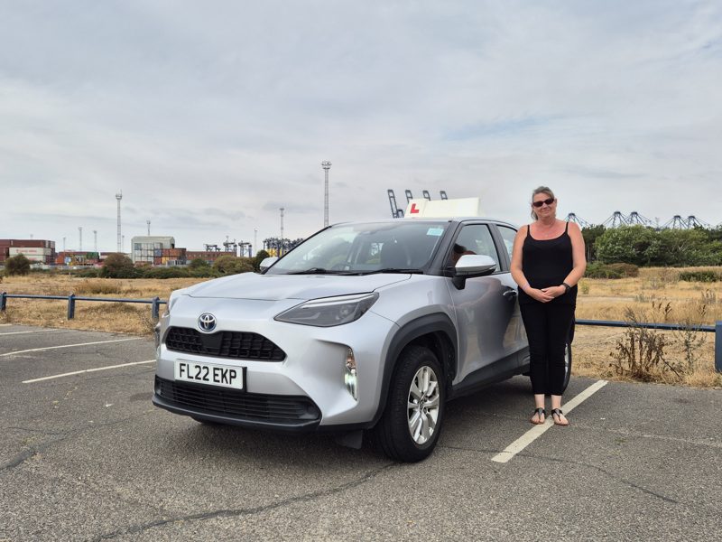 Inez Banfield standing beside the Drive Suffolk Toyota Yaris Cross